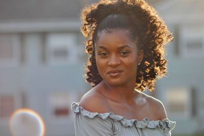 Portrait of young woman standing outdoors