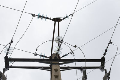 Low angle view of electricity pylon against sky