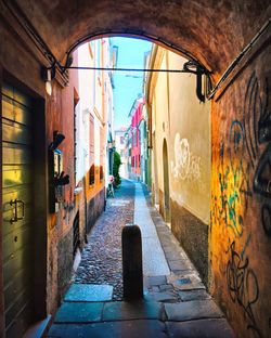 Empty alley amidst buildings in city