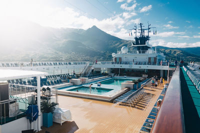 Cruise ship sailing in sea by mountain