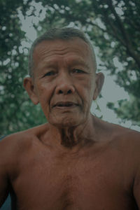 Portrait of shirtless man smiling