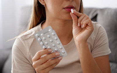 Midsection of woman drinking glass