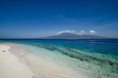 Scenic view of sea against blue sky