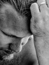 Close-up of thoughtful mid adult man with head in hand