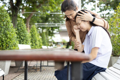 Rear view of couple sitting on table