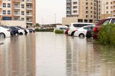 Cars on wet street in city during rainy season