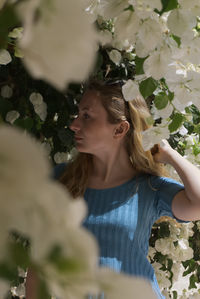 Beautiful woman standing amid flowering plants