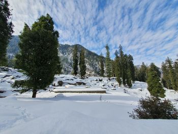 Scenic view of snow covered mountains against sky