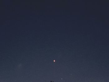 Low angle view of moon against sky at night