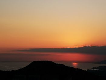 Scenic view of sea against romantic sky at sunset