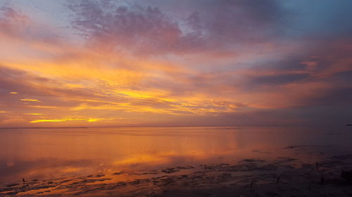 Scenic view of sea against orange sky