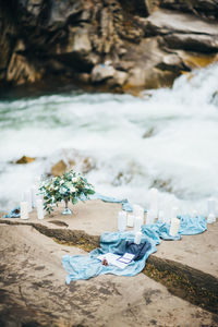 Candles on wood by river