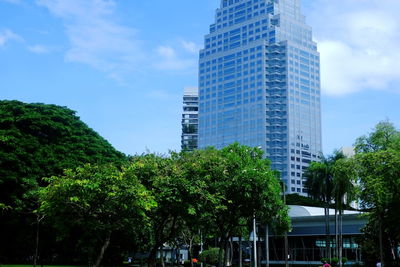 Low angle view of trees and buildings against sky