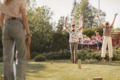Happy senior couple in garden playing kubb