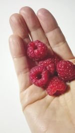 Close-up of hand holding strawberries