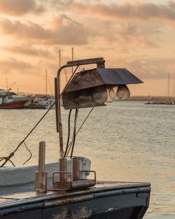 Built structure by sea against sky during sunset