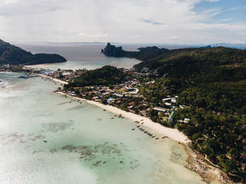 High angle view of sea and cityscape against sky