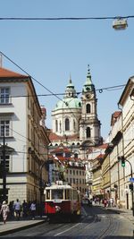 View of city street against blue sky