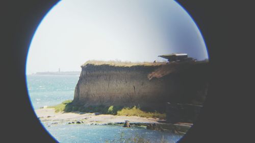 View of sea seen through window