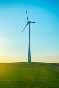 Windmill on field against sky