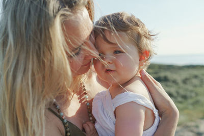 Close up portrait of woman with daughter 