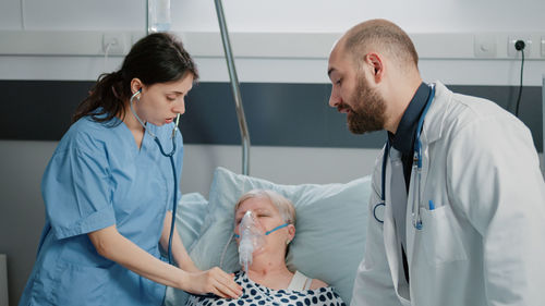 Doctor and nurse examining patient at hospital