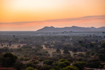 Scenic view of mountains against orange sky