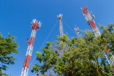 Low angle view of communications tower against clear blue sky