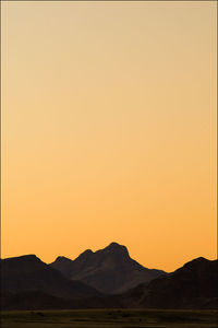 Scenic view of silhouette mountains against clear sky