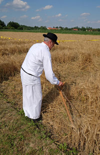 Rear view of man working on field