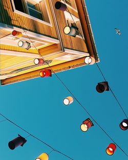 Low angle view of ferris wheel against blue sky