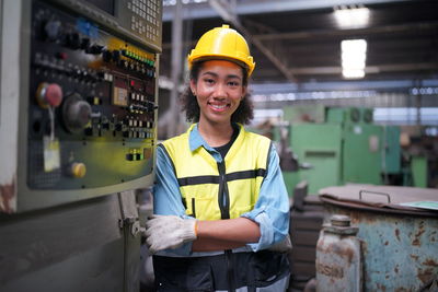 Portrait of man standing in factory