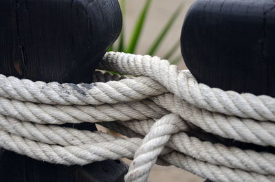 Close-up of rope tied on wooden post