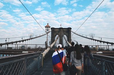 Low angle view of man standing on brooklyn bridge