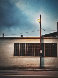 Street light against cloudy sky