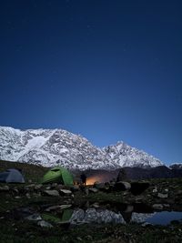 Scenic view of snowcapped mountains against blue sky