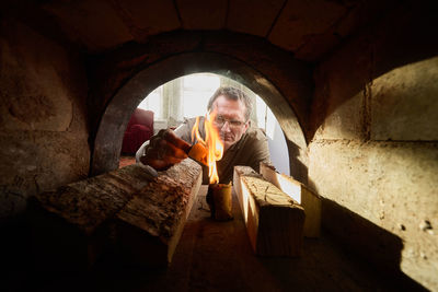 Low angle view of young woman standing in tunnel