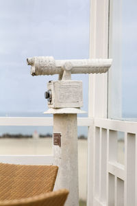 Side view of telescope against the sea