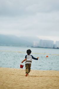 Rear view of boy on beach