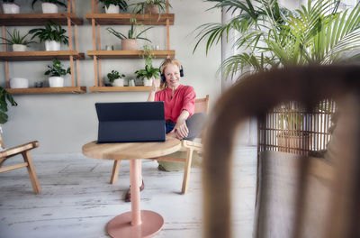 Woman sitting on chair at table