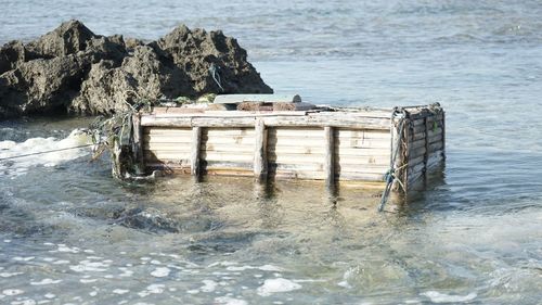 Built structure on rocks by sea