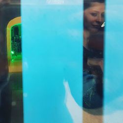 Reflection of woman on mirror in swimming pool