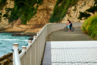 Man on bridge over sea