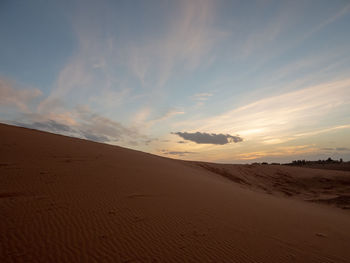 Scenic view of desert against sky during sunset