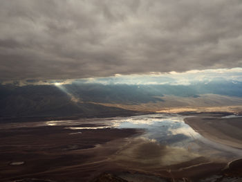 Scenic view of sea against storm clouds