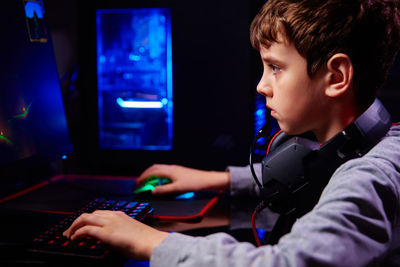 Boy plays computer game at home, gaming addiction