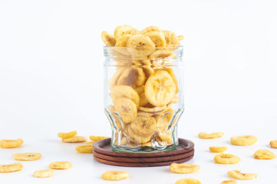 Close-up of bread in jar against white background