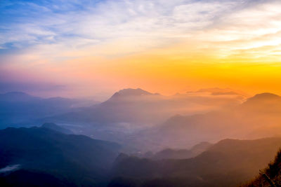 Scenic view of mountains against sky at sunset