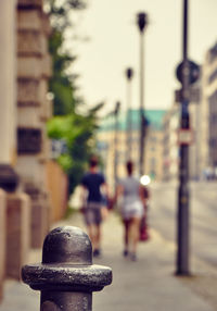 Couple walking on street against buildings