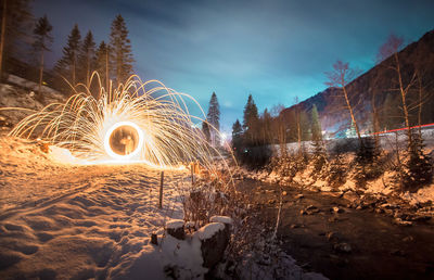 Person spinning illuminated wire wool 